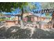 Outdoor kitchen and dining area under a pergola at 17808 N 57Th Pl, Scottsdale, AZ 85254