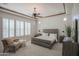Main bedroom with a king-size bed, large windows, and plush carpeting at 17808 N 57Th Pl, Scottsdale, AZ 85254