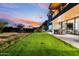 Landscaped backyard with a grassy lawn and modern home at 6311 E Phoenician Blvd # 21, Scottsdale, AZ 85251
