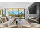 Bright and airy living room with a modern fireplace and golf course views at 6311 E Phoenician Blvd # 21, Scottsdale, AZ 85251