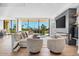 Open living space with fireplace, large windows, and golf course views at 6311 E Phoenician Blvd # 21, Scottsdale, AZ 85251