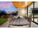 Outdoor patio with long wooden table and wicker chairs at 6311 E Phoenician Blvd # 21, Scottsdale, AZ 85251