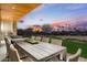 Large patio with a long table, chairs, and sunset views at 6311 E Phoenician Blvd # 21, Scottsdale, AZ 85251