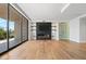 Living area with modern fireplace, wine cellar view, and hardwood floors at 6311 E Phoenician Blvd # 21, Scottsdale, AZ 85251