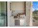 Built-in outdoor kitchen with stainless steel appliances and stone accents at 6311 E Phoenician Blvd # 21, Scottsdale, AZ 85251
