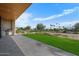Spacious backyard with a patio, putting green, and a view of palm trees at 6311 E Phoenician Blvd # 21, Scottsdale, AZ 85251