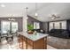 Open concept kitchen and living area with island and seating at 649 N 67Th Dr # 25, Phoenix, AZ 85043