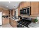 Modern kitchen with stainless steel appliances and granite countertops at 649 N 67Th Dr # 25, Phoenix, AZ 85043