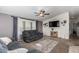 Spacious living room with two sofas and a large TV at 649 N 67Th Dr # 25, Phoenix, AZ 85043