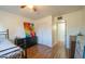 Bright bedroom with double bed, wood floors, and colorful art at 2047 W Maryland Ave, Phoenix, AZ 85015