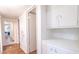 Clean hallway with white cabinets and wood flooring at 2047 W Maryland Ave, Phoenix, AZ 85015