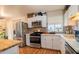 Modern kitchen with white cabinets, quartz countertops and patterned backsplash at 2047 W Maryland Ave, Phoenix, AZ 85015