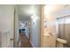 Hallway view of bathroom with white vanity and shower at 2047 W Maryland Ave, Phoenix, AZ 85015