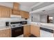 Well-equipped kitchen with wood cabinets and a breakfast bar at 9822 E Main St # 10, Mesa, AZ 85207