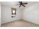 Spacious bedroom with ceiling fan, window, and carpeted floor at 9822 E Main St # 10, Mesa, AZ 85207