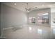 Spacious living room with large windows and ceiling fan at 7469 W Monona Dr, Glendale, AZ 85308