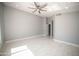 Bright bedroom with ceiling fan and large window at 7469 W Monona Dr, Glendale, AZ 85308