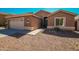 One-story home with a tan exterior and gravel landscaping at 7469 W Monona Dr, Glendale, AZ 85308