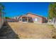 Large backyard with covered patio and grassy area at 7469 W Monona Dr, Glendale, AZ 85308