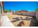 Backyard with grassy area and covered patio at 7469 W Monona Dr, Glendale, AZ 85308