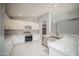 Modern kitchen with white cabinets and stainless steel appliances at 7469 W Monona Dr, Glendale, AZ 85308