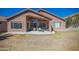 Home's backyard with covered patio and lawn at 7469 W Monona Dr, Glendale, AZ 85308
