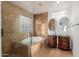 Bathroom with double sinks, a soaking tub and a walk-in shower at 944 S Grand --, Mesa, AZ 85210