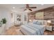 Bright bedroom with wood-look walls and a ceiling fan at 944 S Grand --, Mesa, AZ 85210