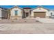 New construction home exterior with two-car garage at 21048 E Arroyo Verde Dr, Queen Creek, AZ 85142