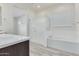 Modern bathroom with soaking tub, walk-in shower, and tiled floor at 21048 E Arroyo Verde Dr, Queen Creek, AZ 85142