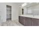 Bathroom with double vanity, large mirror, and walk-in closet at 21048 E Arroyo Verde Dr, Queen Creek, AZ 85142