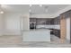 Modern kitchen with island, dark cabinets, and stainless steel appliances at 21048 E Arroyo Verde Dr, Queen Creek, AZ 85142