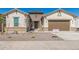 New construction home exterior with two-car garage at 21048 E Arroyo Verde Dr, Queen Creek, AZ 85142