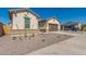 New construction home exterior with two-car garage at 21048 E Arroyo Verde Dr, Queen Creek, AZ 85142