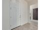 Bright entryway with modern white door and wood-look tile floor at 21048 E Arroyo Verde Dr, Queen Creek, AZ 85142