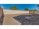 Empty lot backyard with block wall and some small trees at 21048 E Arroyo Verde Dr, Queen Creek, AZ 85142
