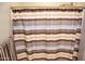 Shower stall with striped shower curtain at 12956 W El Sueno Ct, Sun City West, AZ 85375