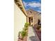 Front entrance with stonework and walkway lined with plants at 12956 W El Sueno Ct, Sun City West, AZ 85375