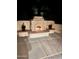 Cozy outdoor fireplace at night at 12956 W El Sueno Ct, Sun City West, AZ 85375