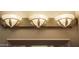 Elegant three-light vanity fixture, ideal for a modern bathroom at 12956 W El Sueno Ct, Sun City West, AZ 85375