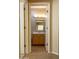 Bathroom with light wood cabinets and mirror at 12956 W El Sueno Ct, Sun City West, AZ 85375