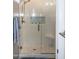 Glass shower with tile surround, mosaic accents, and built-in seat at 12956 W El Sueno Ct, Sun City West, AZ 85375