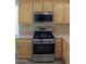 Stainless steel kitchen appliances and light wood cabinets at 12956 W El Sueno Ct, Sun City West, AZ 85375