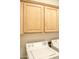 Laundry room featuring upper cabinets and a new washer and dryer at 12956 W El Sueno Ct, Sun City West, AZ 85375