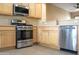 Kitchen with stainless steel appliances and light wood cabinets at 12956 W El Sueno Ct, Sun City West, AZ 85375