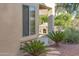 Landscaped backyard with a stone fireplace at 12956 W El Sueno Ct, Sun City West, AZ 85375