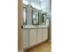 Double vanity bathroom with white cabinets and quartz countertops at 12956 W El Sueno Ct, Sun City West, AZ 85375