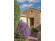 Front entrance with stonework and purple flowering bushes at 12956 W El Sueno Ct, Sun City West, AZ 85375