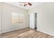 Bright bedroom with wood-look floors, ceiling fan, and spacious closet at 10722 W Jefferson St, Avondale, AZ 85323