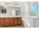 Bathroom boasts double vanity, tub, and window at 10722 W Jefferson St, Avondale, AZ 85323